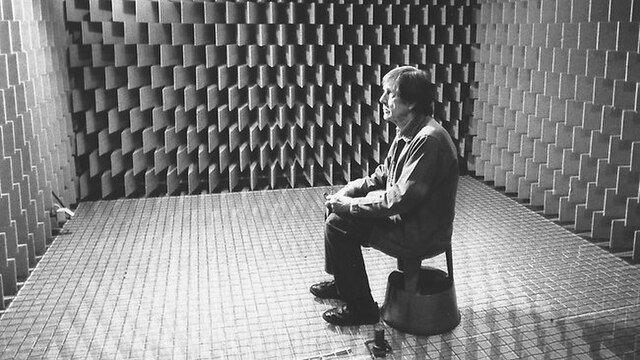 John Cage sitting in the anechoic chamber at Harvard University in 1951. Here he realises that absolute silence does not exist. This is what motivated him to compose "4'33". Source: Wikimedia Commons